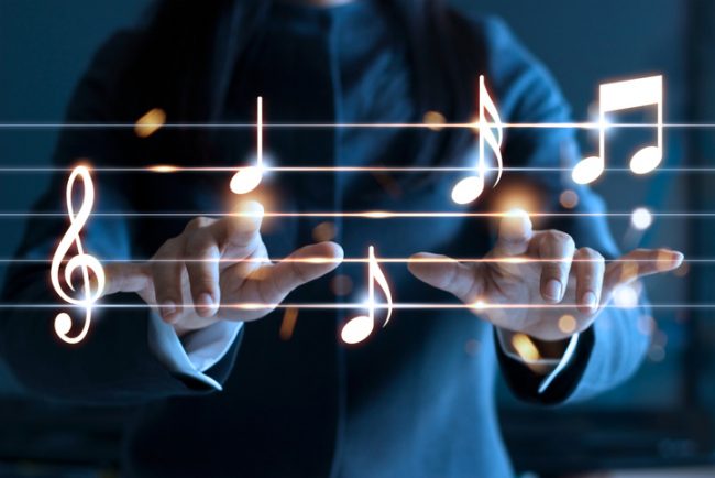 Woman hands playing music notes on dark background, music concept